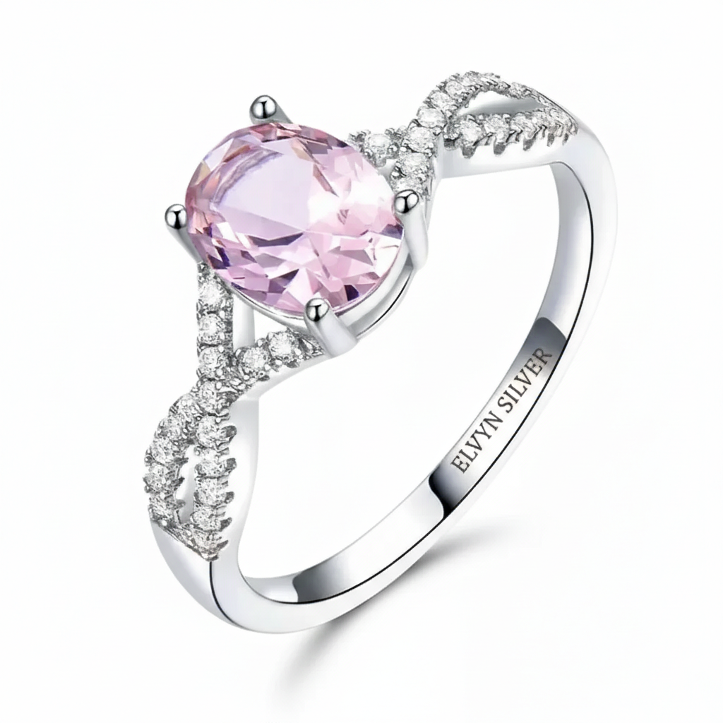 Oval pink morganite ring in 925 sterling silver with twisted band and accent stones. Elvyn Silver engraving inside the oval morganite ring band Side view of twisted band silver ring with sparkling accent stones.